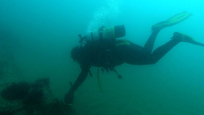 Diver inspecting outfall pipe